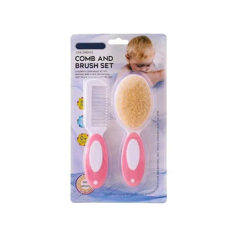 Infant comb and brush set with pink handles, white comb, and tan oval brush pad