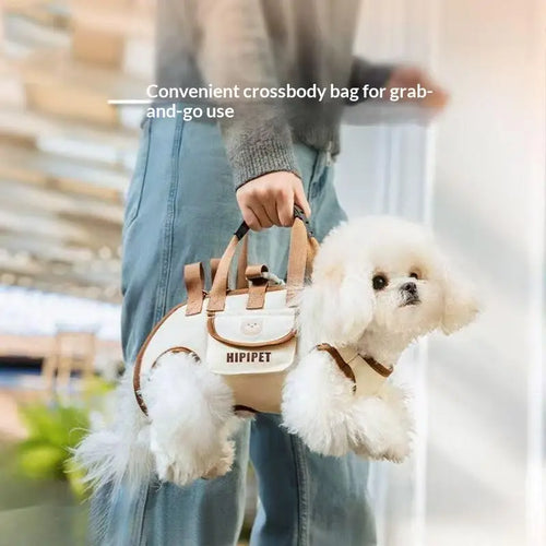 Crossbody pet carrier bag with adjustable shoulder strap and leash, held with small dog