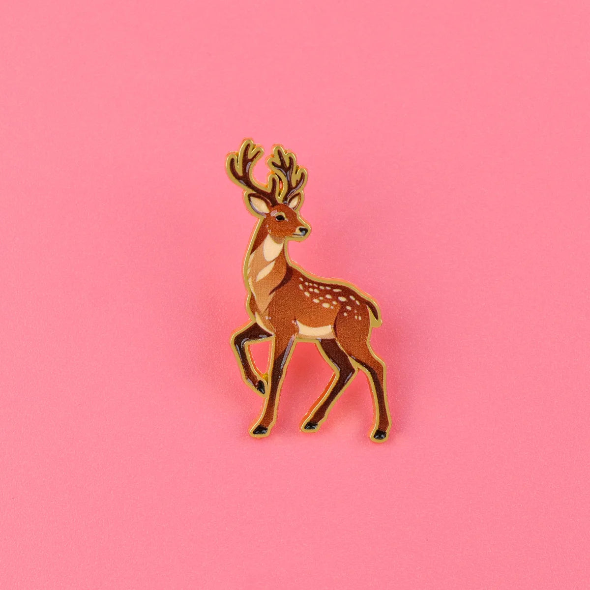 Brown deer enamel pin with antlers and white speckled dots