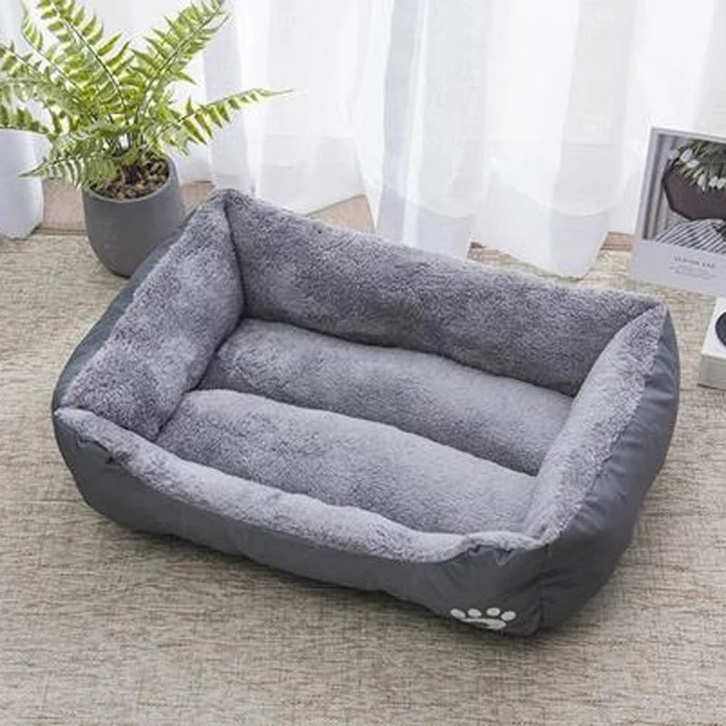 Plush dog bed with gray inner cushion and gray outer walls, paw logo on front